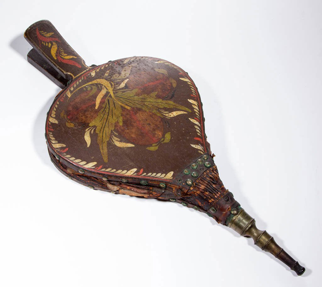 PAINT-DECORATED HEARTH BELLOWS: PAINT-DECORATED HEARTH BELLOWS, Spanish brown ground with hand-painted polychrome fruit and plumes, brass nozzle and leather trimmings. 19th century. 17 3/4" L.Paint in very good condition with grime,