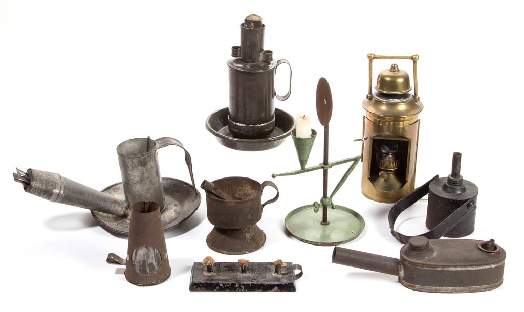 ASSORTED SHEET-IRON / TIN AND BRASS LIGHTING ARTICLES,: ASSORTED SHEET-IRON / TIN AND BRASS LIGHTING ARTICLES, LOT OF NINE, including a brass cylinder-form lantern, an oblong flat shop lamp, a mechanical lard example, and an ovoid-form and a cylinder-form 