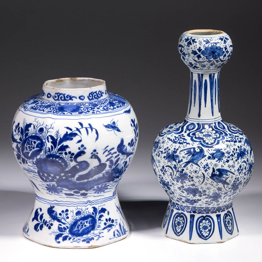 DUTCH DELFT TIN-GLAZED EARTHENWARE VASES, LOT OF TWO: DUTCH DELFT TIN-GLAZED EARTHENWARE VASES, LOT OF TWO, comprising one garlic-shaped vase with octagonal base, bulbous paneled center, narrow neck with bulbous top, and a baluster-shaped vase with octag