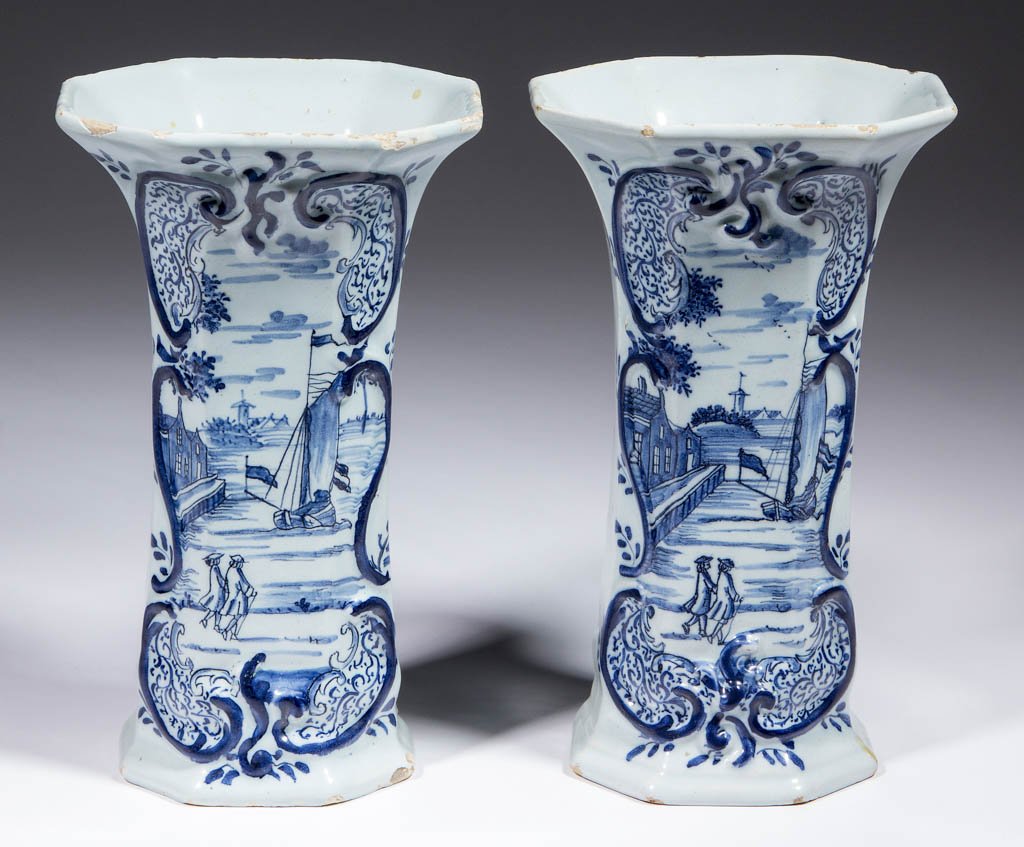 DUTCH DELFT TIN-GLAZED EARTHENWARE NEAR PAIR OF: DUTCH DELFT TIN-GLAZED EARTHENWARE NEAR PAIR OF GARNITURE VASES, octagonal paneled shape, having relief-molded cartouches on front with figures walking near a pier with a ship and landscape surrounded
