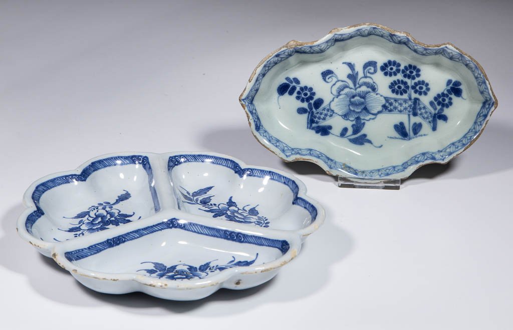 ENGLISH DELFT TIN-GLAZED EARTHENWARE ARTICLES, LOT OF: ENGLISH DELFT TIN-GLAZED EARTHENWARE ARTICLES, LOT OF TWO, comprising one spoon tray, possibly made in Bristol, England with a painted fence and floral design on interior; and one three-tray divided s