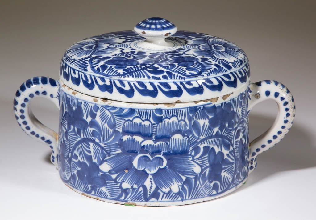 DUTCH DELFT TIN-GLAZED EARTHENWARE COVERED DISH /: DUTCH DELFT TIN-GLAZED EARTHENWARE COVERED DISH / CHEESE BOX, having a double rim on underside of cover, two loop handles opposite one another, and bold blue floral designs on sides and cover. Unmarke