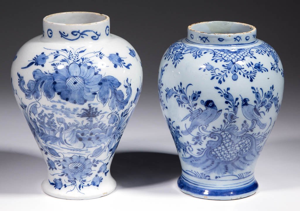 DUTCH DELFT TIN-GLAZED EARTHENWARE VASES, LOT OF TWO: DUTCH DELFT TIN-GLAZED EARTHENWARE VASES, LOT OF TWO, both with baluster shape and tight, flaring foot, one having a bird and floral design and the other having a female figure with a basket surrounde