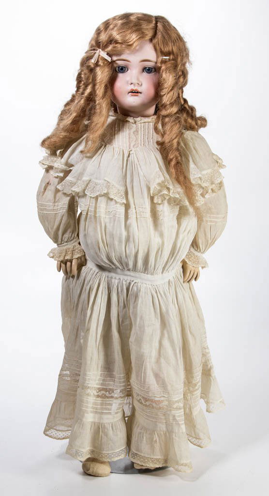 GERMAN BISQUE-HEAD DOLL: GERMAN BISQUE-HEAD DOLL, socket head incised "192 / 17", fixed eyes, open mouth with teeth, pierced ears, painted eyebrows and lashes, wig, jointed composition body. Old clothes. Late 19th/early 20th