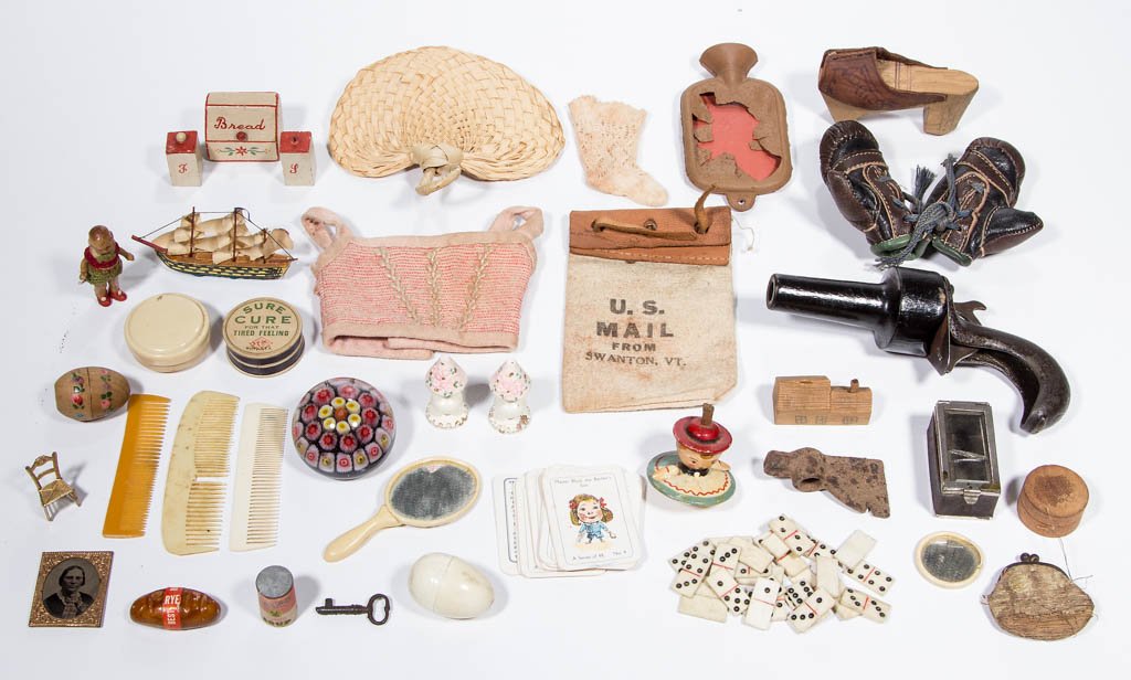 ASSORTED DOLL AND TOY ARTICLES: ASSORTED DOLL AND TOY ARTICLES, uncounted lot, including a cast-iron and wood clicker pistol, a pair of leather boxing gloves, and bone dominoes. 19th and 20th century. Gloves 2 1/2" H. Very good to e