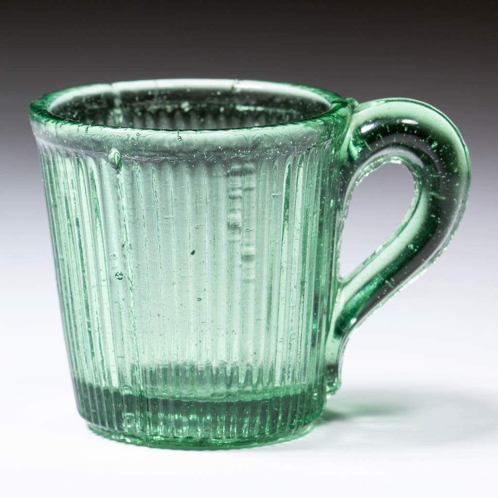 FINE RIB / REEDED (OMN) TOY LEMONADE: FINE RIB / REEDED (OMN) TOY LEMONADE, medium green. Boston & Sandwich Glass Co., New England Glass Co., and possibly others. Third quarter 19th century. 1 3/4" H, 1 3/4" D rim. Undamaged. Literature: 
