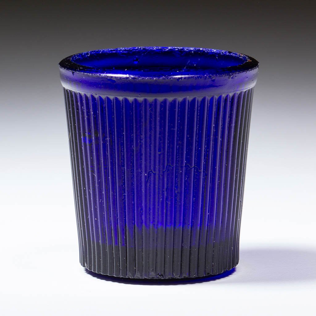 FINE RIB / REEDED (OMN) TOY TUMBLER: FINE RIB / REEDED (OMN) TOY TUMBLER, deep cobalt blue. Boston & Sandwich Glass Co., New England Glass Co., and possibly others. Third quarter 19th century. 1 3/4" H, 1 5/8" D rim. Undamaged with typic