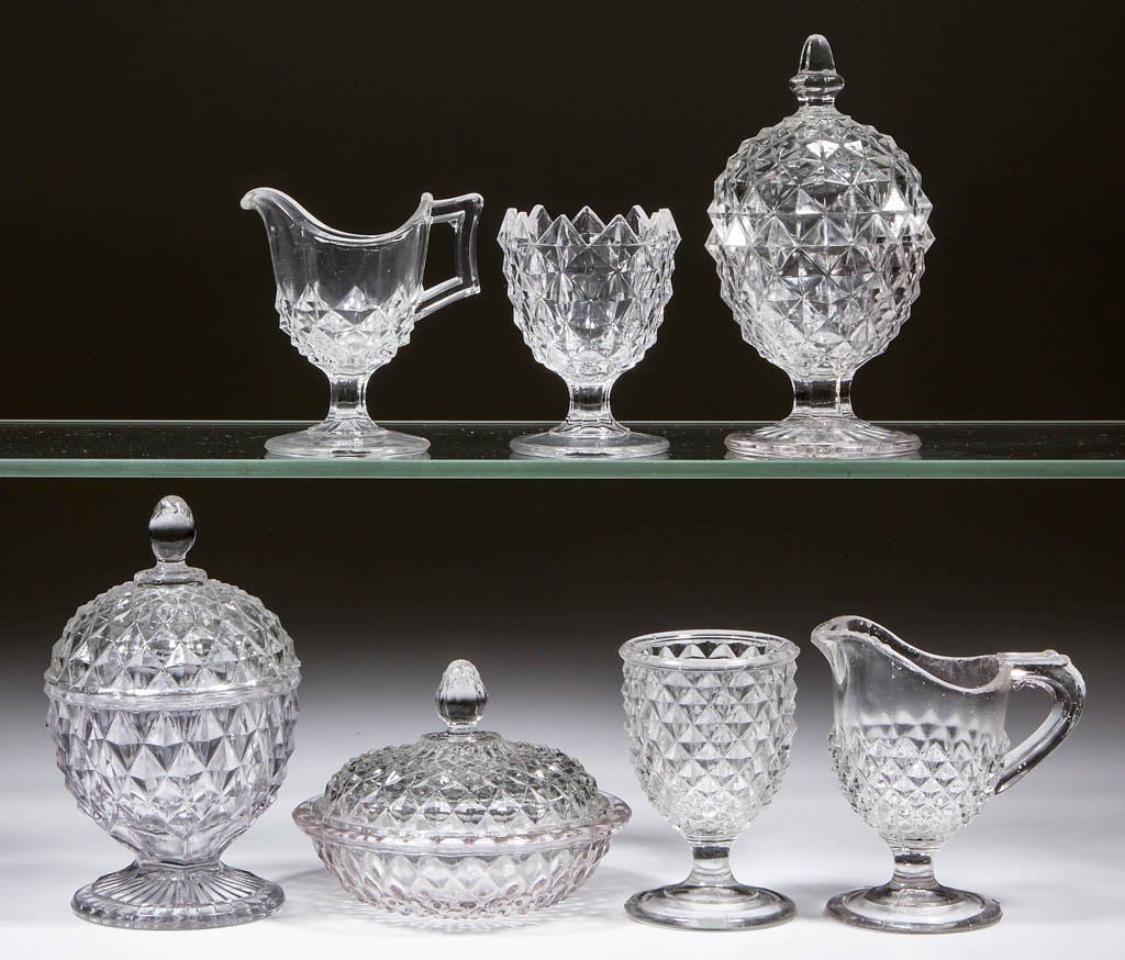 AMAZON / SAWTOOTH MITERED CHILDREN'S GLASS TOY: AMAZON / SAWTOOTH MITERED CHILDREN'S GLASS TOY ARTICLES, LOT OF SEVEN, colorless, including a four-piece table set. Bryce Brothers. Circa 1890. 3" to 5" HOA. One sugar with a chip to three teeth, base