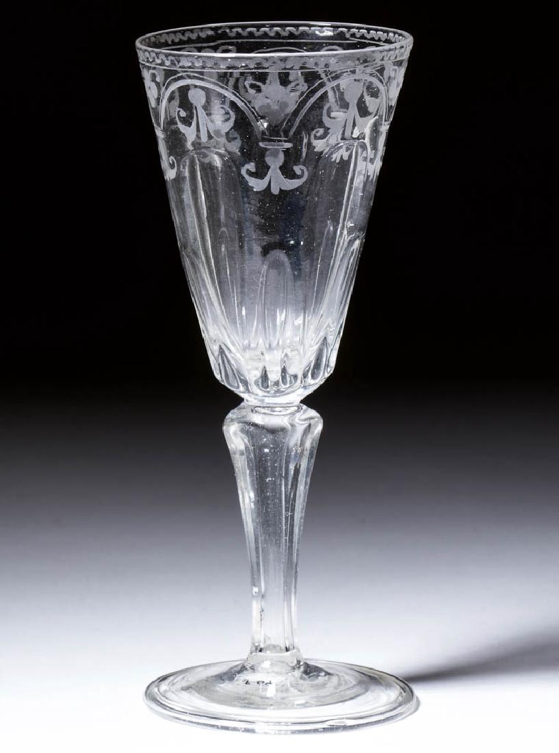 CONTINENTAL PATTERN-MOLDED AND ENGRAVED MOLDED-PEDESTAL: CONTINENTAL PATTERN-MOLDED AND ENGRAVED MOLDED-PEDESTAL WINE GLASS, colorless non-lead glass, deep pointed round funnel bowl with alternating short and tall flutes, engraved arch and fleur-de-lis deco