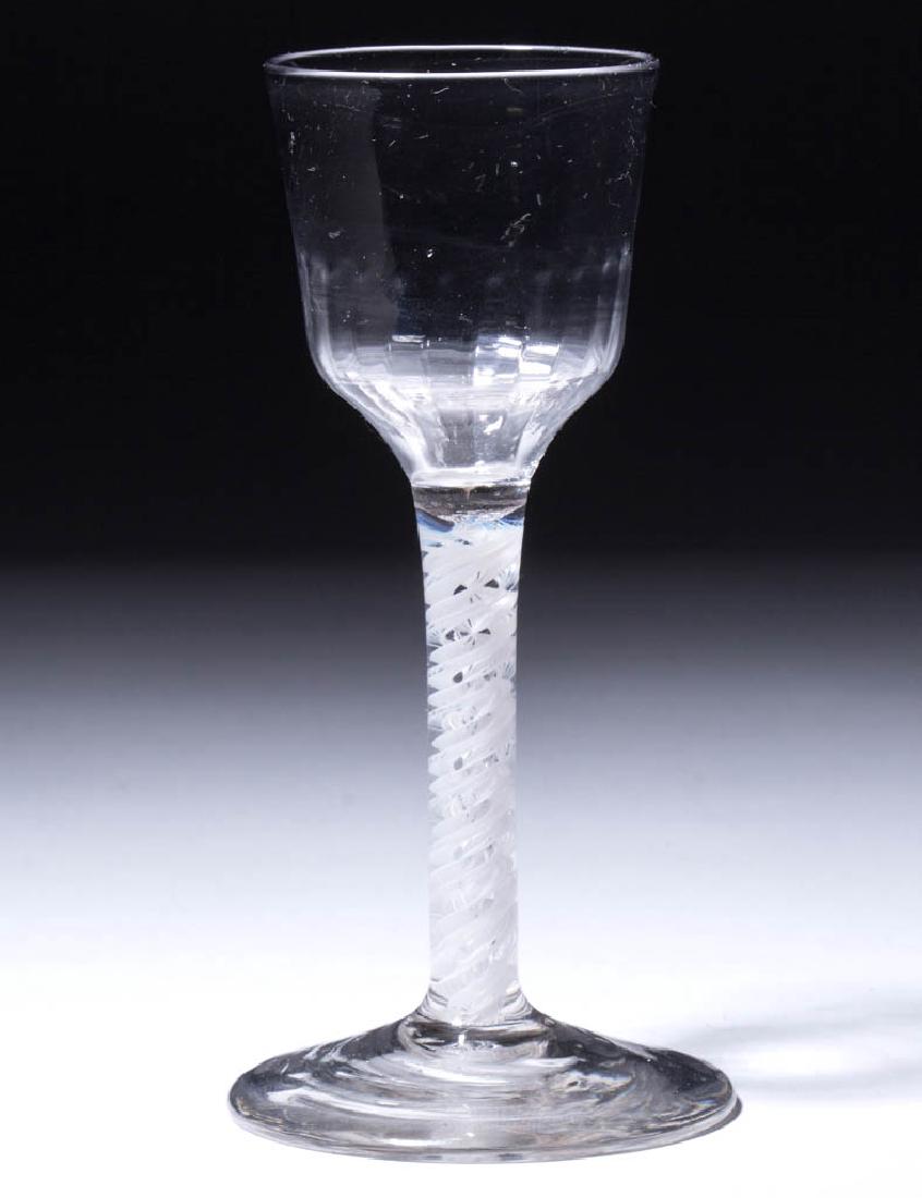 ENGLISH PATTERN-MOLDED OPAQUE-TWIST WINE GLASS: ENGLISH PATTERN-MOLDED OPAQUE-TWIST WINE GLASS, colorless lead glass, ogee bowl with 24 basal flutes, raised on a stem containing a pair of corkscrews, one mostly solid and the other multi-ply, conica