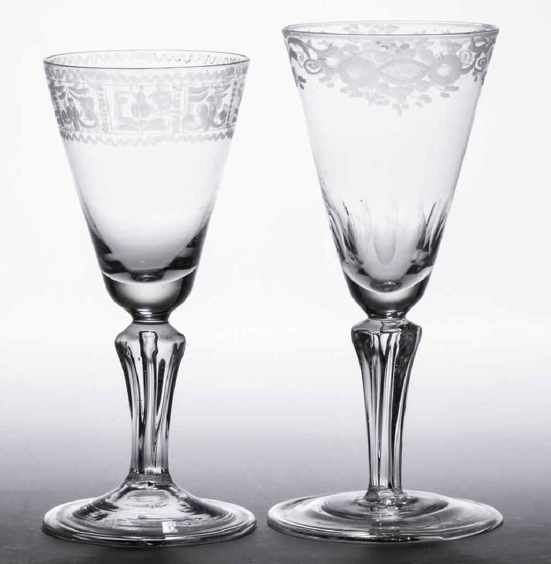 CONTINENTAL FREE-BLOWN AND ENGRAVED MOLDED-PEDESTAL: CONTINENTAL FREE-BLOWN AND ENGRAVED MOLDED-PEDESTAL WINE GLASSES, LOT OF TWO, colorless non-lead glass, each deep pointed round funnel bowl with foliate decoration below the rim, one with cut ovals ar