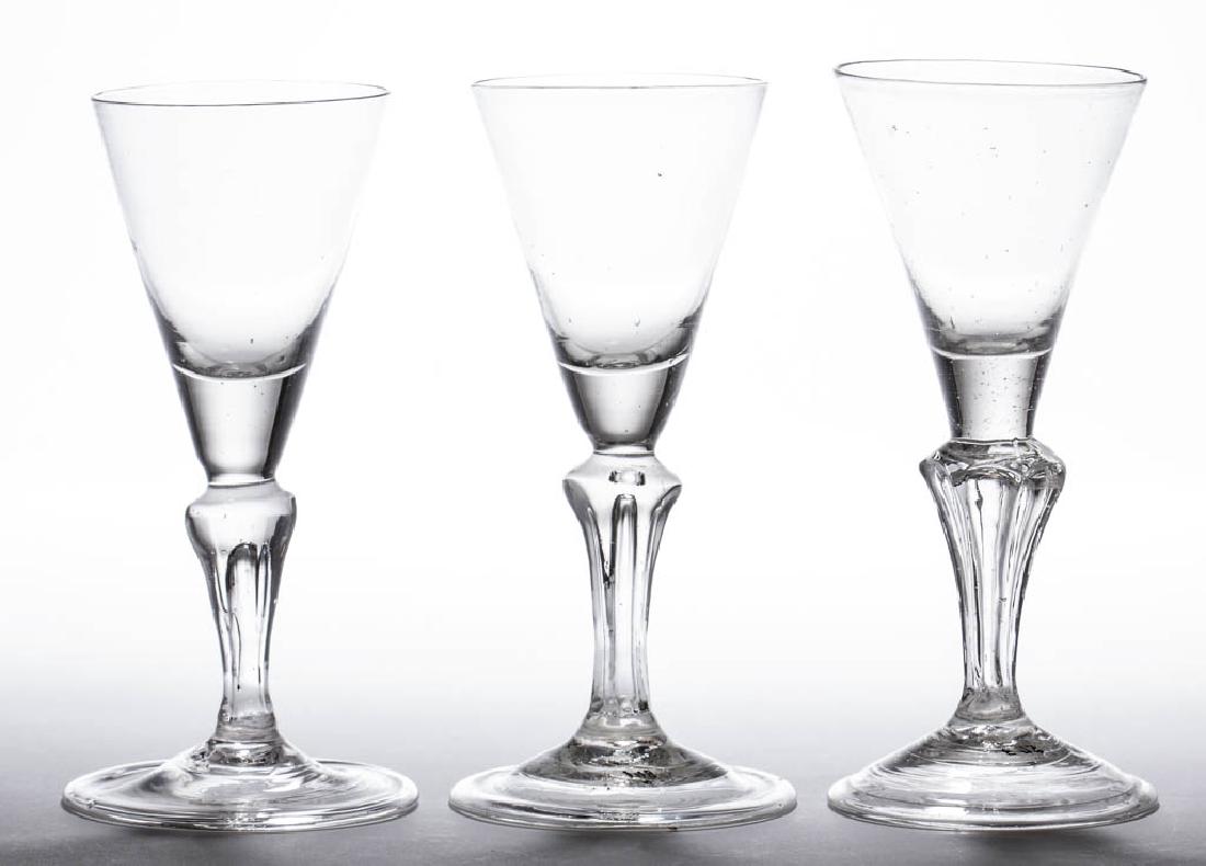 CONTINENTAL FREE-BLOWN MOLDED-PEDESTAL WINE GLASSES,: CONTINENTAL FREE-BLOWN MOLDED-PEDESTAL WINE GLASSES, LOT OF THREE, colorless non-lead glass, each funnel bowl with solid base raised on a teared six-sided stem, and conical folded foot with rough pont