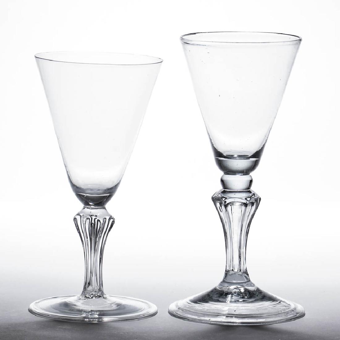 CONTINENTAL FREE-BLOWN MOLDED-PEDESTAL WINE GLASSES /: CONTINENTAL FREE-BLOWN MOLDED-PEDESTAL WINE GLASSES / GOBLETS, LOT OF TWO, colorless non-lead glass, each funnel bowl with solid base, one raised on a cushioned knop above a teared six-sided stem, oth