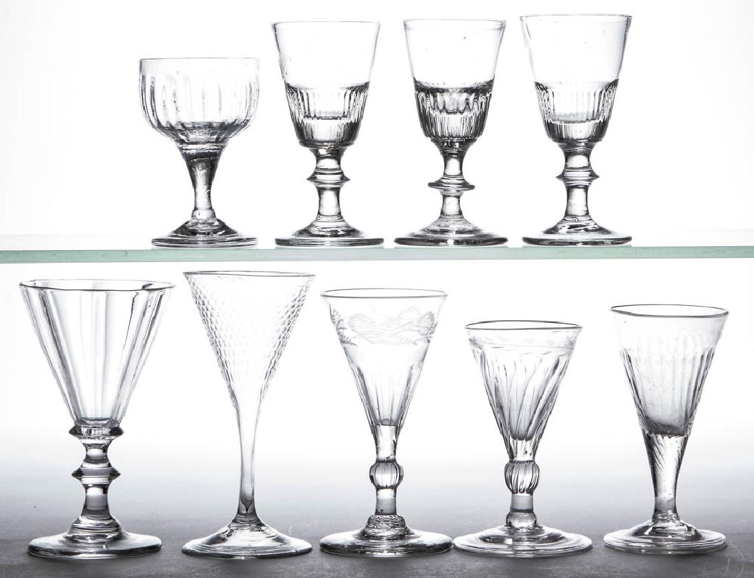 ASSORTED PATTERN-MOLDED WINE GLASSES, LOT OF NINE: ASSORTED PATTERN-MOLDED WINE GLASSES, LOT OF NINE, colorless lead and non-lead glass, including rib, flute, and honeycomb moldings, two with engraved decoration below rim, drawn and knopped stems, thr