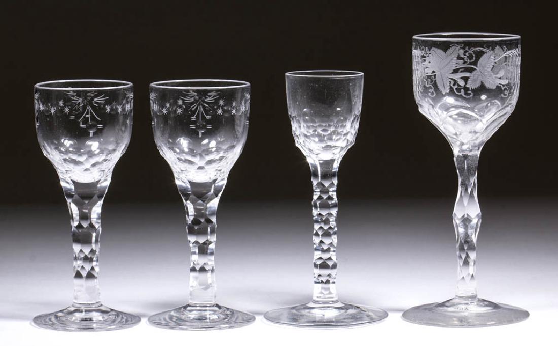ENGLISH FREE-BLOWN, CUT, AND ENGRAVED FACET-STEM WINE: ENGLISH FREE-BLOWN, CUT, AND ENGRAVED FACET-STEM WINE GLASSES, LOT OF FOUR, colorless lead glass, comprising a pair with ogee bowls cut and engraved with oval-and-star swags and tassels below the rim,