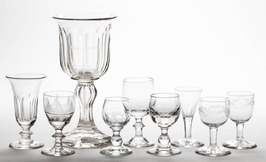 ASSORTED CUT AND ENGRAVED DRINKING ARTICLES, LOT OF: ASSORTED CUT AND ENGRAVED DRINKING ARTICLES, LOT OF NINE, colorless, comprising seven wines, a jelly glass, and a large chalice/goblet. Various makers. 19th century. 3 1/2" to 8 1/2" H. One drapery de