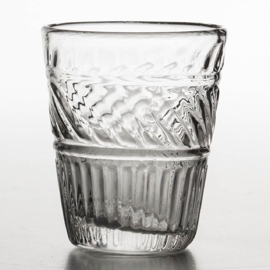 BLOWN-MOLDED GI-20 DIMINUTIVE TAPER TUMBLER: BLOWN-MOLDED GI-20 DIMINUTIVE TAPER TUMBLER, colorless, upper ribs swirled slightly to right, plain base with rough pontil mark. Produced from the caster bottle mold. Possibly Boston & Sandwich Glass 