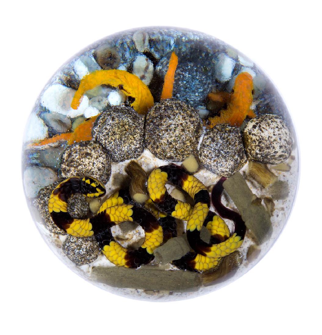 GORDON SMITH STUDIO ART GLASS LAMPWORK MAGNUM: GORDON SMITH STUDIO ART GLASS LAMPWORK MAGNUM PAPERWEIGHT, "Koi Pond" series, depicting a yellow and black snake, finely detailed including scales and two-tone eyes, on sandy ground, slithering among