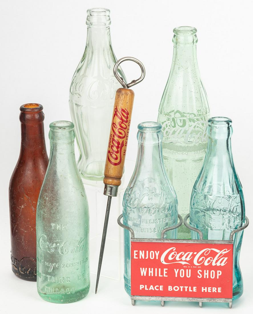Coca-Cola: Six Bottles of Various Ages and Shopping: Coca-Cola: Six Bottles of Various Ages and Shopping Cart Bottle Holder. Coca-Cola collectors enjoy acquiring all aspects of the legendary brand, and certainly collecting bottles and containers spannin