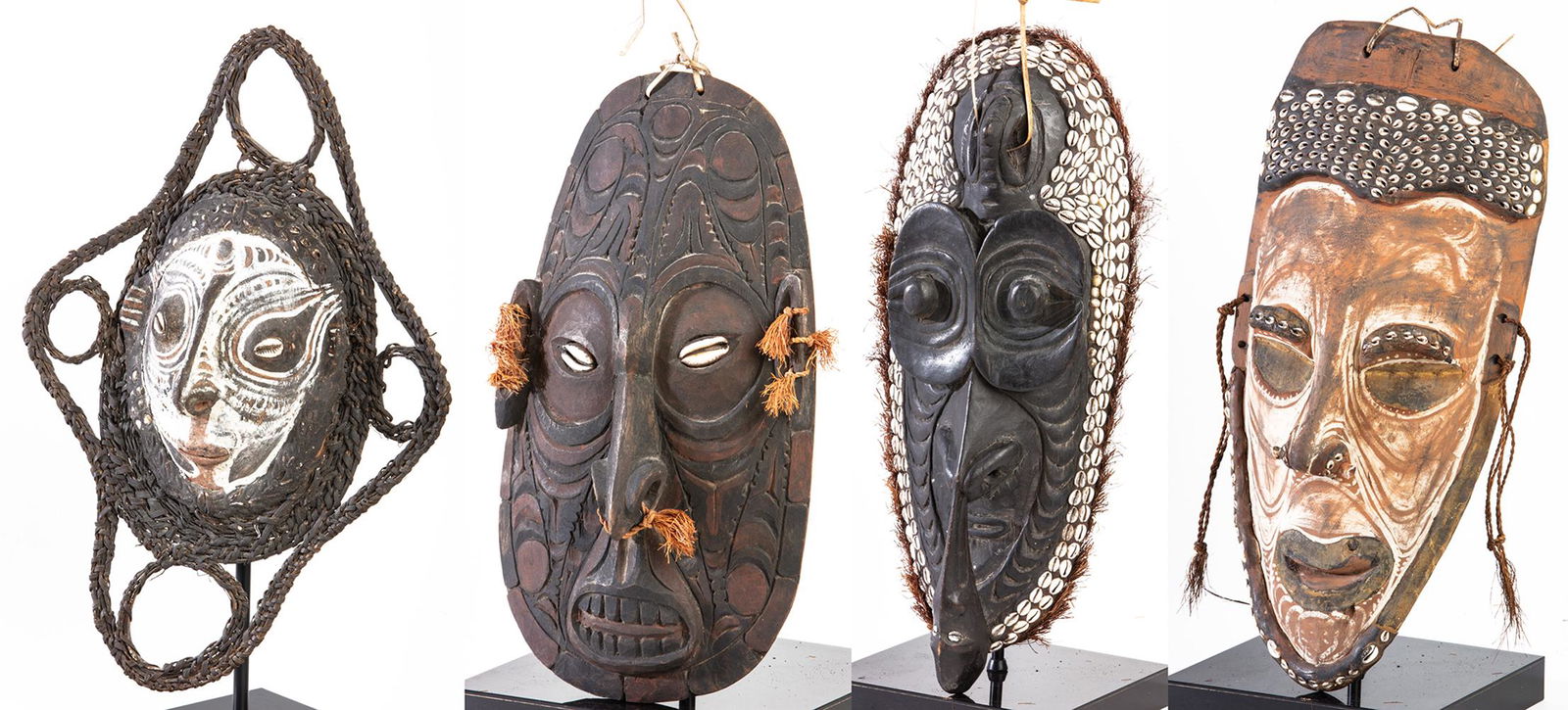 Fine Collection of 4 Various Sized Sepik River, Papua,: Fine Collection of 4 Various Sized Sepik River, Papua, New Guinea Hand Carved Wood Masks Decorated with Shells, Raffia and Organic Pigments. Making for dramatic and striking wall decor, 4 carved wood