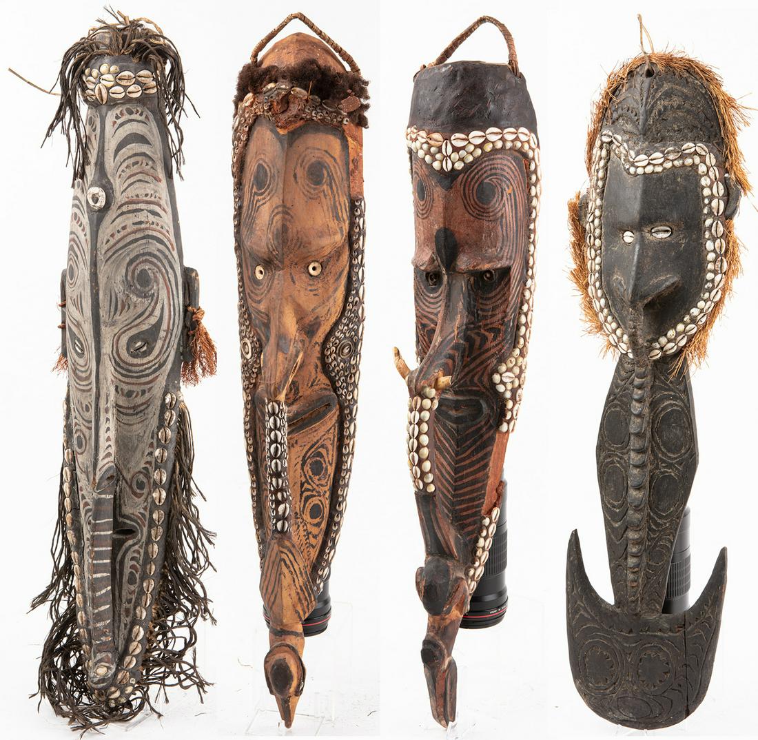 Four (4) Sepik River Papua New Guinea Masks; Carved: Four (4) Sepik River Papua New Guinea Masks; Carved Wood, Earthen Pigments, Cowry Shells and Raffia, One Small Figure. Very appealing Middle Sepik River, Papua New Guinea tribal masks. The largest 32"