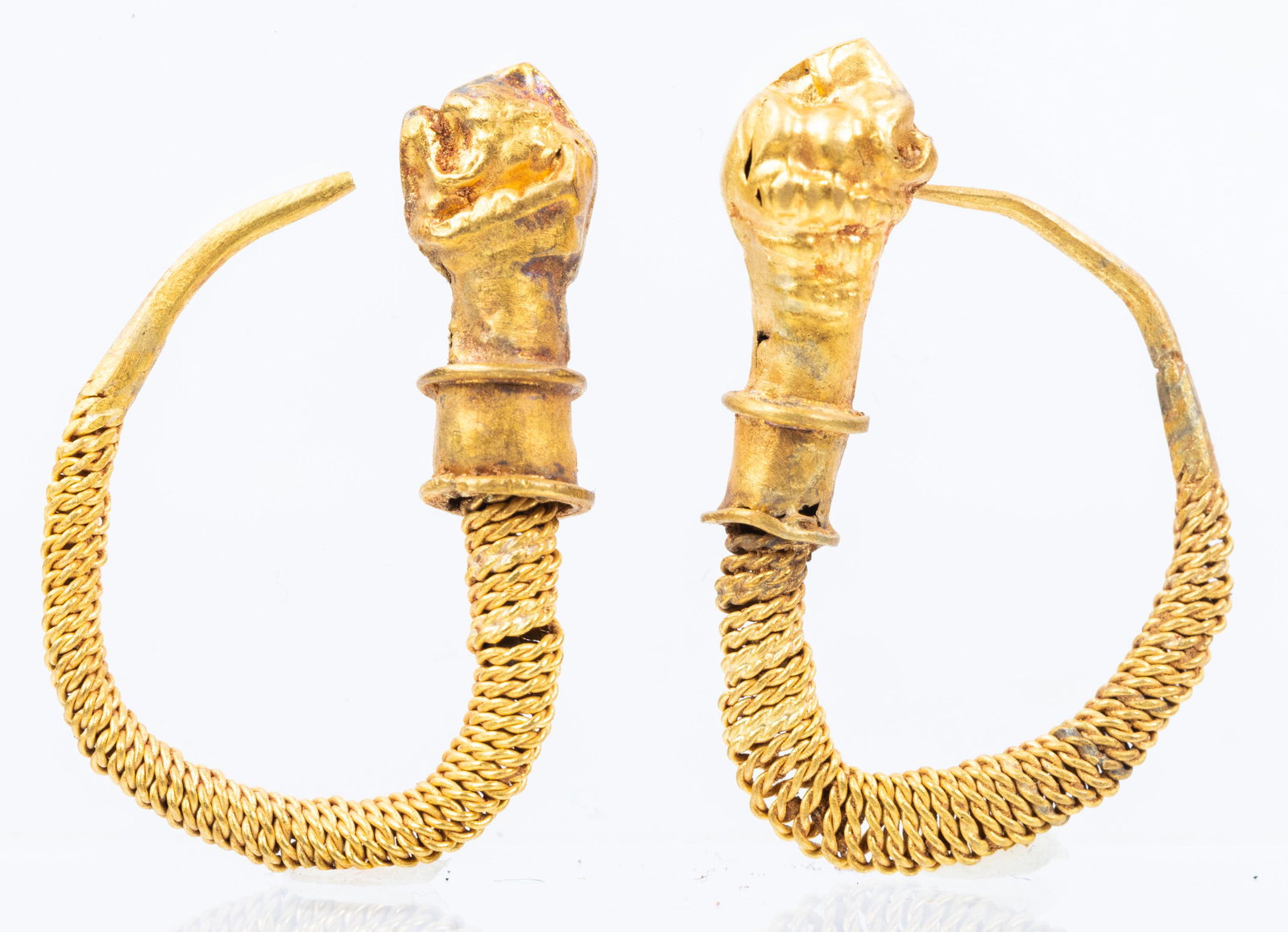 Greek 3rd Century B.C. Lion's Head Earrings in High: Greek 3rd Century B.C. Lion's Head Earrings in High Karat Yellow Gold. Unusual 3rd Century B.C. earrings from Greece with 23K yellow gold threads wrapped around hoops ending with very interesting lion