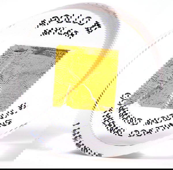 Apollo 11, 1969, FLOWN Gold Foil: Apollo 11, 1969, FLOWN Gold Foil (1x1") mounted in a clear lucite cylinder (2.5x1") that is engraved on the bottom: "Apollo XI / Mylar / Command Module / Thermal Coating.&#