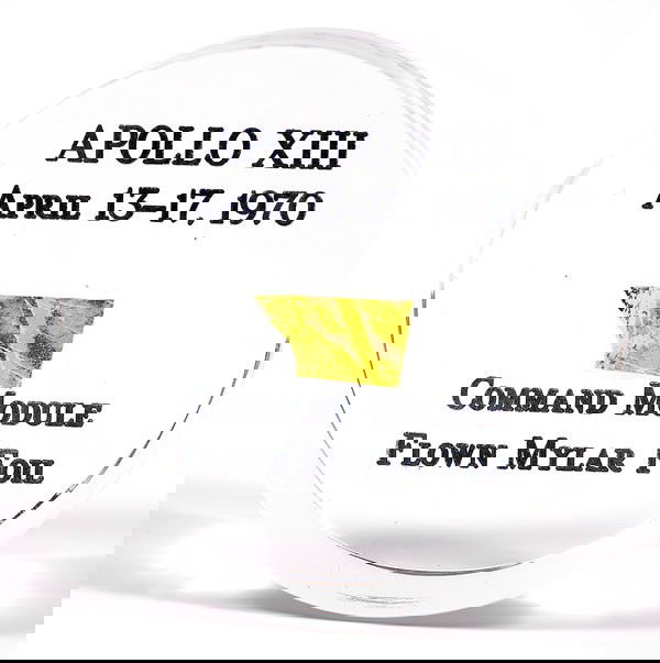 Apollo 13, 1970, FLOWN Gold Foil: Apollo 13, 1970, FLOWN Gold Foil (.5x.25") mounted in a clear lucite cylinder (2.5x1") that is inscribed: "Apollo XIII / April 13-17, 1970 / Command Module / Flown Mylar Fo