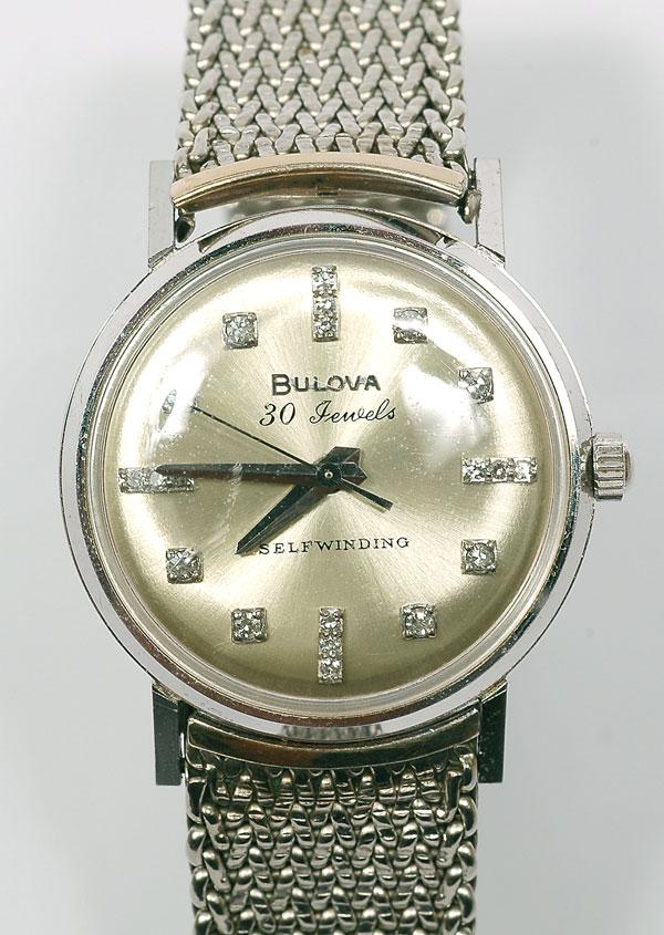 Gent's Bulova 14K White Gold, Diamond Wristwatch: Gent's Bulova 14K White Gold, Diamond Wristwatch. Having a self winding/automatic movement, 14k white gold circular case, water proof, shock resistant, silver dial with diamond markers, completed
