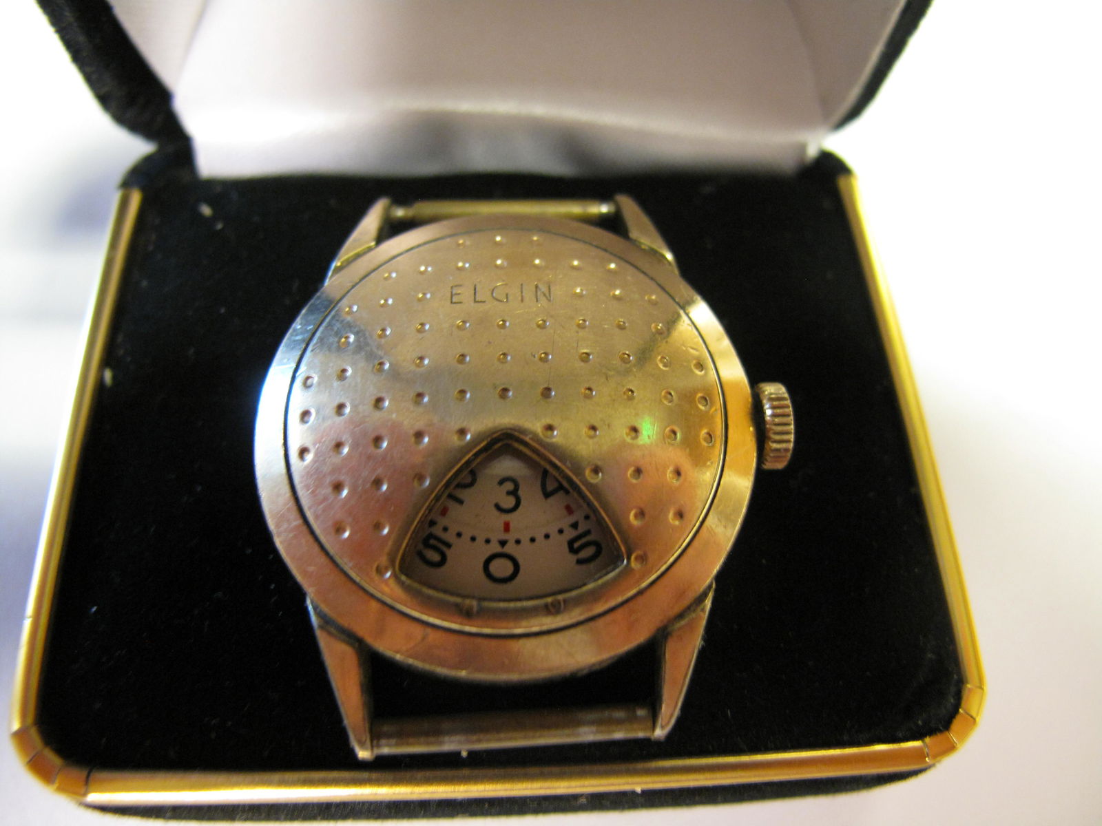 Scarce, Highly Sought, Elgin 717 Golf Ball Direct Read Jump Hour Wrist Watch, 1957: Scarce, Highly Sought, Elgin 717 Golf Ball Direct Read Jump Hour Wrist Watch, 1957. From the year 1957, an Elgin wrist watch in the shape of a golf ball with a jump hour mechanism that is highly uniqu