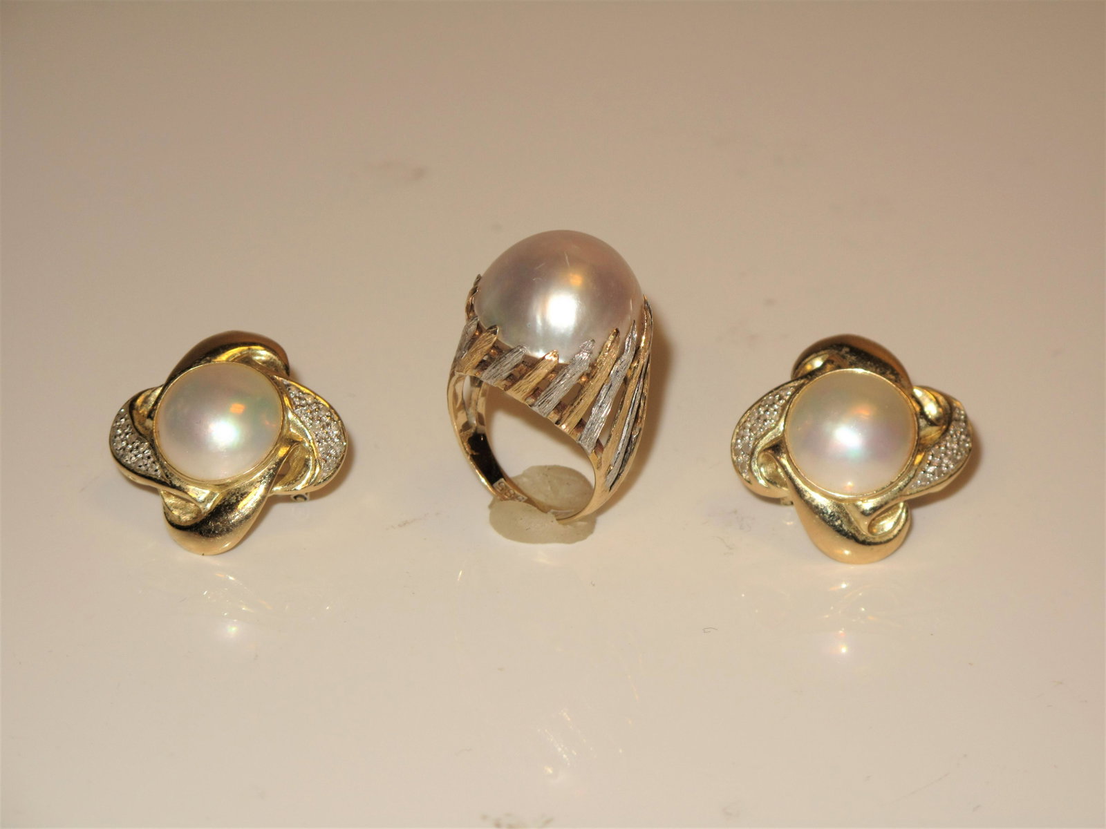 Lady's 14K Yellow and White Gold Earrings and Ring all with Mabe Pearls: Lady's 14K Yellow and White Gold Earrings and Ring all with Mabe Pearls. Mabe pearls are unique in how they?re created. Grown attached to the inside wall of the penguin oyster (rather than inside the 