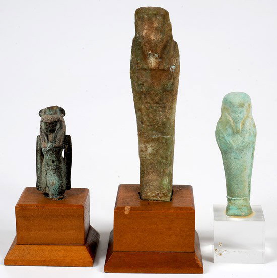 A Group of 3 Small Ancient Egyptian Faience Figure: A Group of 3 Small Ancient Egyptian Faience Figures. Consists of: 2 Ushabti figures and a fragmented amulet of a pharaoh. Both Ushabti have been repaired. Each on a stand. Size: 2" to 4". Lot
