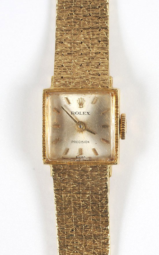 Lady's Rolex Precision, 18K Yellow Gold Wristwatch: Lady's Rolex Precision, 18K Yellow Gold Wristwatch. Having a Rolex 17 jewel manual movement, silver dial with gold stick markers, gold hands, set in a rectangular shaped 18k yellow gold case and c