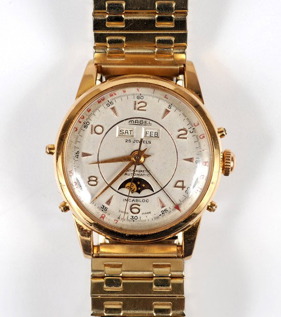 Mabel 18K Yellow Gold Triple Calendar Moonphase Wr: Mabel 18K Yellow Gold Triple Calendar Moonphase Wristwatch. Having a circular silver dial with Arabic & abstract gold markers, gold hands and sweep seconds hand, 25 jewel automatic movement, approxima