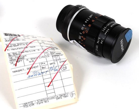 STS-53, 1992, FLOWN Nikon 55mm., 1:28 f/2.8, Micr: STS-53, 1992, FLOWN Nikon 55mm., 1:28 f/2.8, Micro-NIKKOR Lens. This lens (P/N SED33101581-301, S/N 1012) is engraved as part of the unit. There are pieces of blue velcro attached to the lens,