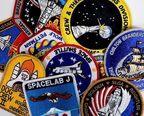 Shuttle Program, c1980s, Crew/Mission Patches: Shuttle Program, c1980s, Crew/Mission Patches. A fascinating 1/2 carton lot of patches including some duplication. Some have velcro on the back showing use in astronaut training. These were consigned 