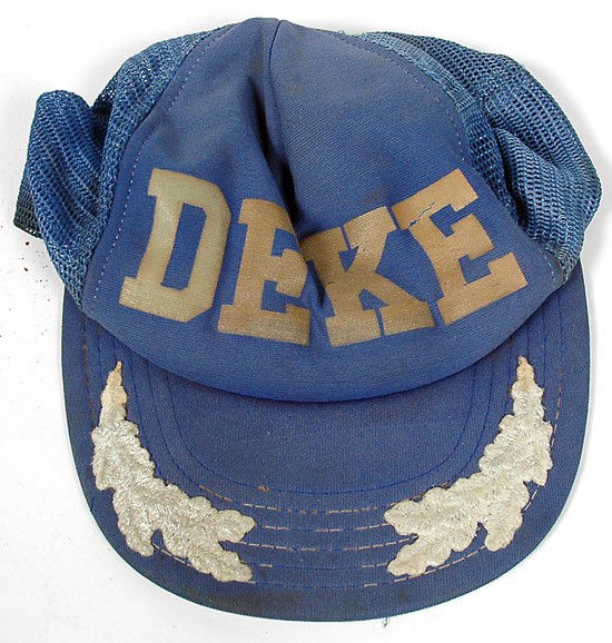 ASTP, 1975, Deke Slayton's Headgear: ASTP, 1975, Deke Slayton's "Headgear". Lot of two different "hats" including a light blue baseball cap with a large gold "DEKE" on the cloth/mesh top and silver "Scramb