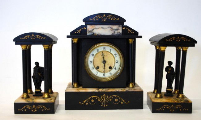 French Marble & Slate Garniture Set: Marble and Black slate Mantel Clock w/ Enamel and Brass Dial, engraving, columns. Matching Garnitures have one soldier and one maiden standing within matching four column porticos. Clock Garnitures 9