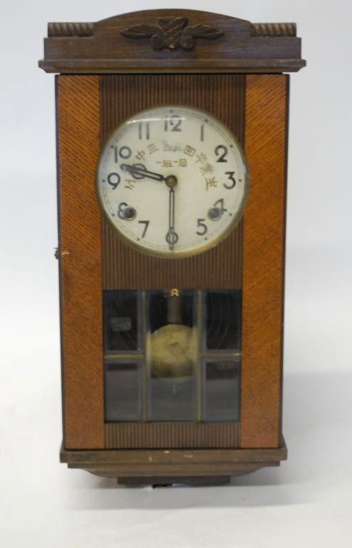 Meiji Japanese Wall Clock: Metal Dial with Japanese Characters. Sectional leaded glass pendulum window. Mid 20th Century. 18" tall.