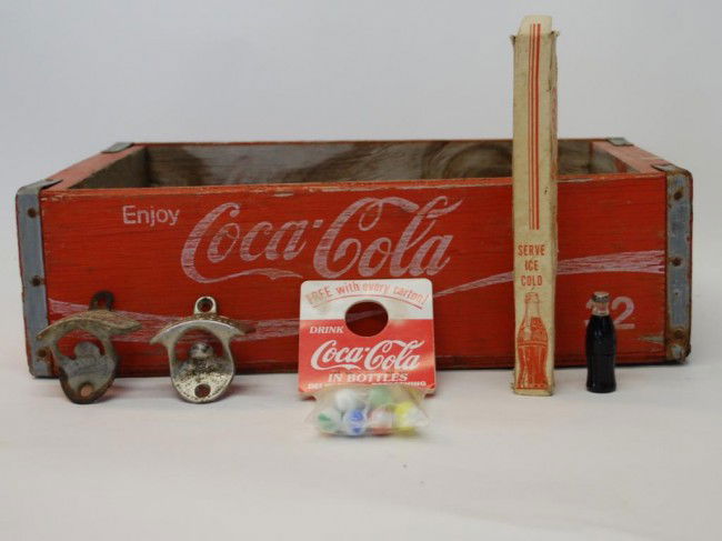 6 Coca-Cola Collectible Pieces: Wooden Bottle Case, 1950's/60's Lighter, Unopened bag of Marbles, Ice Pick, 2 Wall Mount Openers.