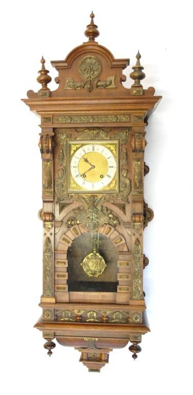 Lenzkirch Regulator Clock-Ornate Carved Walnut: Case featuring Ormolu Mountings. This is an unusually ornate clock by the noted Black Forest Clock Maker. Key Wind, Brass Face with Gilt Center and Roman Numeral Hour Chapter Ring , surrounded by Arab