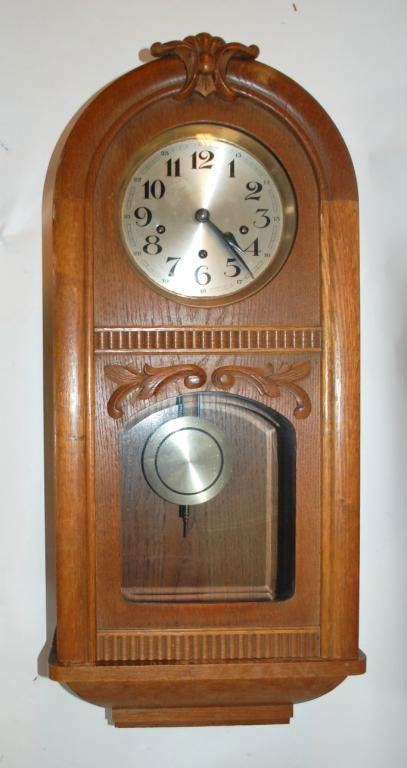 German Regulator Wall Clock: Oak Case with applied carvings, crest needs to be reattached, metal dial, key wind, 8 chimes, brass works marked 15181. 31" tall