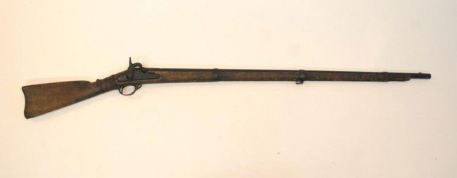 Model 1862 Springfield: 40" Barrel Painted Black covering all marks, Muzzle loading, C shaped hammer, 2 leaf sight, iron trigger guard, lock marked "1862" and "U.S. Springfield". Missing ramrod. Cracking on stock at wrist..