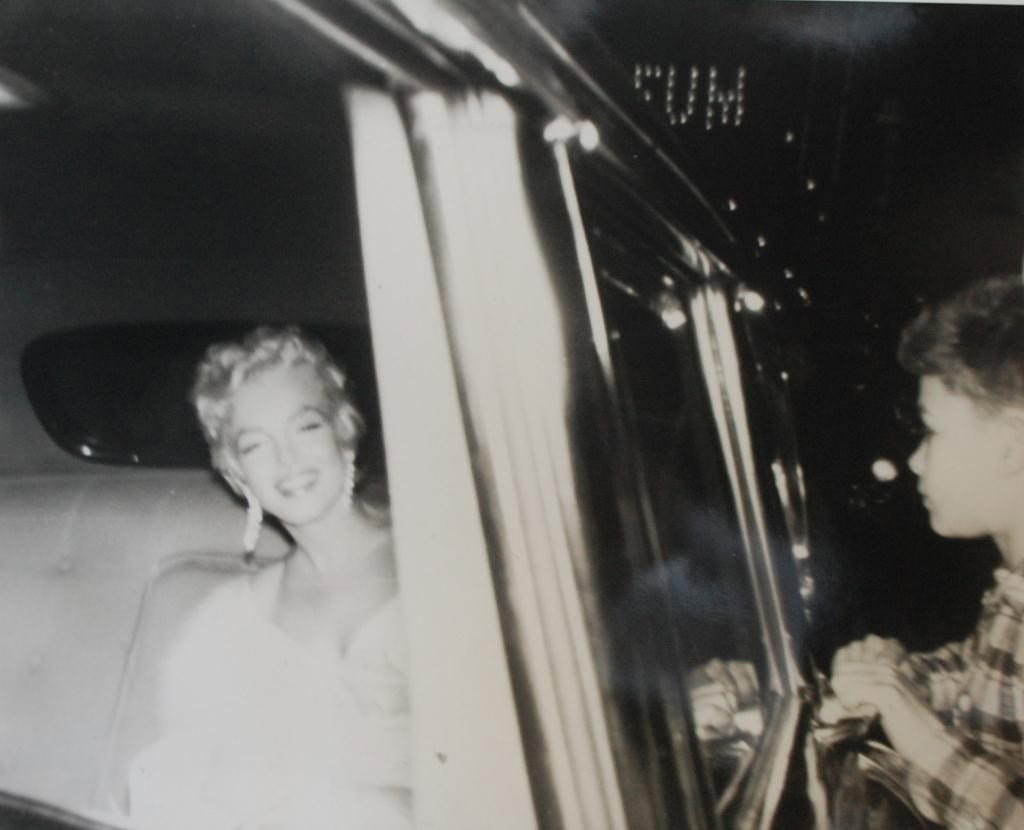 Marilyn Monroe Silver Gelatin Photograph 16" x 20": Original Photograph of Marilyn Monroe dressed in a white gown sitting in the back of a Limousine with a small boy just on the other side of the window hoping for a glimpse of the star. Rare image prin
