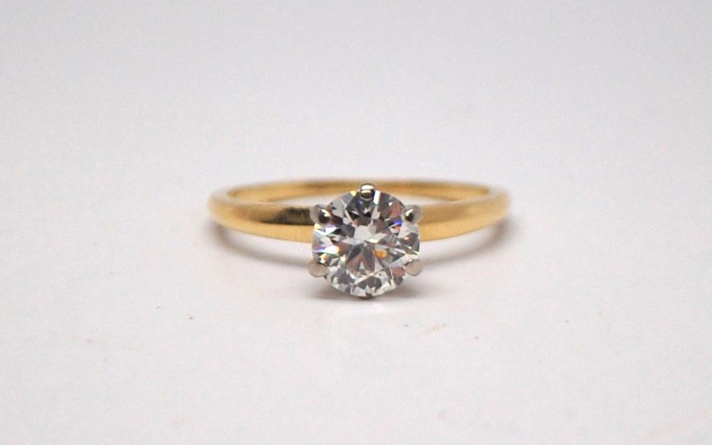 Diamond and 14K Gold Solitaire Ring: Approximate 1.03 Carat Round Cut Diamond set in 14K Gold Setting. Diamond Color J, Clarity SI-1. Size 4 1/2