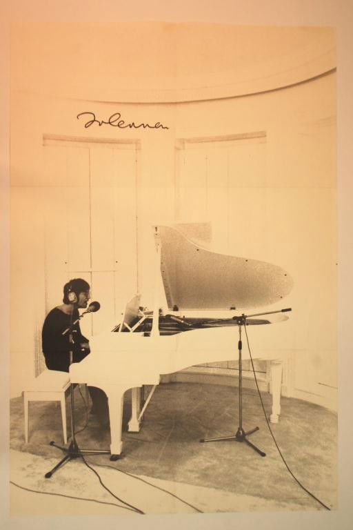 John Lennon Autographed Imagine Poster: "Imagine" poster depicts John Lennon at the piano from the photograph by Peter Fordham. Autographed by Lennon with black marker in top left corner. 22" x 33" .