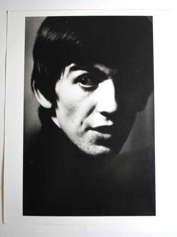 George Harrison-1962 Hatami Photograph: Shahrokh Hatami Signed Photograph- Portrait of Beatle George Harrison. Signed on reverse by photographer and labeled George Harrison Beatles 1962 AP. 1995 printing of the photo. 11" x 14"