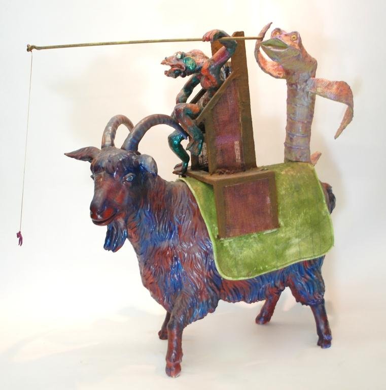 Folk Art Painted NC Goat Sculpture: Humorous Sculpture commissioned in 2008 by the city of Hendersonville NC for their annual apple festival- the goats decorated the streets. The sculpture features a blue and red goat being ridden by a 