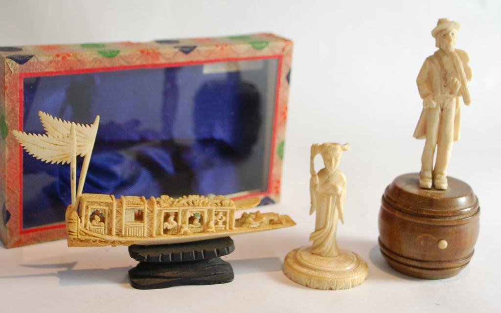 3 Carved Ivory Pieces: 4" ivory boat in original box, man on wood barrel with fiddle (no bow) 4 3/4" tall, carved asian woman 2 3/4" tall.