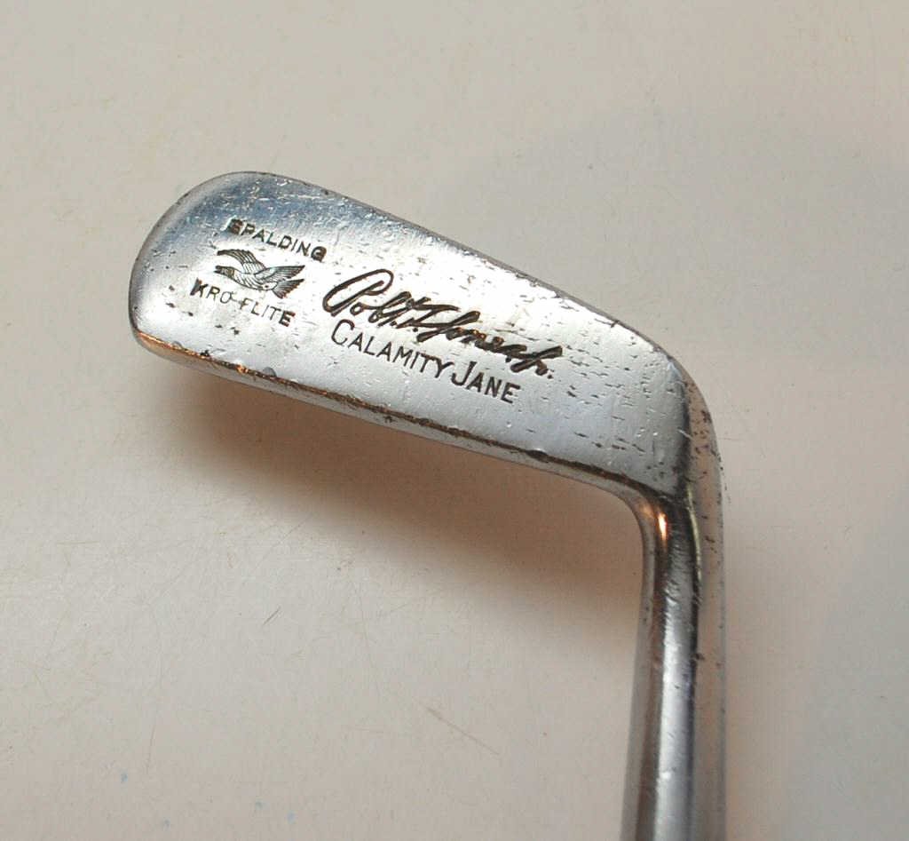 Smooth Faced Bobby Jones Jr. Calamity Jane Putter: Marked "Spalding Kroflite". Hickory Shaft. The original calamity jane had the three windings that are present on this piece, although they are a later addition. Includes a 1993 framed Golf Magazine ar